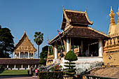 Vientiane, Laos - Surrounded by a cluster of pointed minor stupas the huge Pha That Luang shined under the warm light of the sunset.  